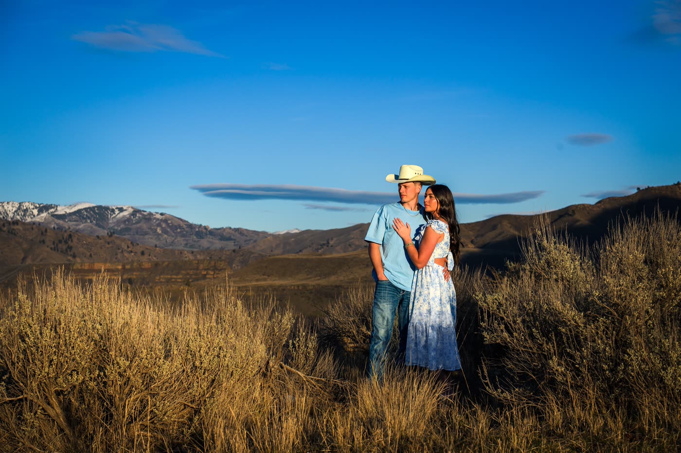 Couple embracing in a mountain landscape at golden hour